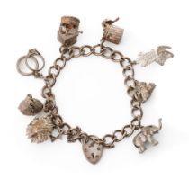 Silver charm bracelet with various charms to include a hedgehog, a pair of rabbits, a well and