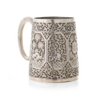 Early 20th century Indian silver tankard with heavily embossed decoration, with exotic animals,