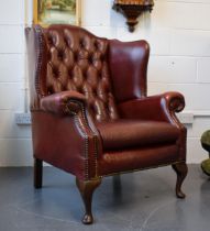 Vintage leather Queen Anne style Chesterfield single wingback chair in oxblood. A good example of