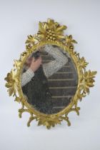 Victorian or earlier carved wooden wall hanging mirror with grape and vine decoration, gilt
