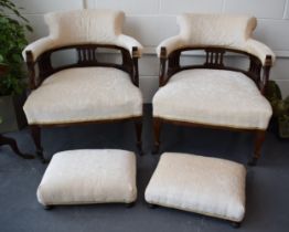 Pair of Edwardian library chairs on original casters with matching footstools. Recently