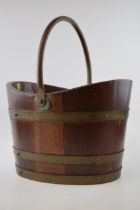 Coopered teak and brass bound bucket, with brass swingover handle, made using wood from HMS
