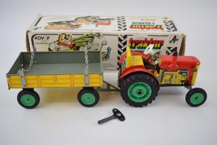 Boxed Zetor Traktor / Tractor and trailer, Kovap Czechoslovakia, in red colourway, with yellow