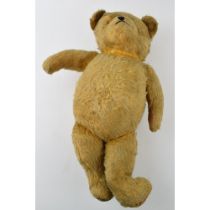 Early to mid 20th century teddy bear with glass eyes and voice box (non working), 45cm long.
