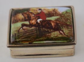 A silver pill box marked .925 with hunting scene depicting man on horseback jumping over a gate.