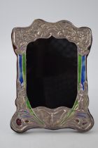 Sterling silver fronted photo frame with enamelled decoration in the Art Nouveau style, 20.5cm tall.