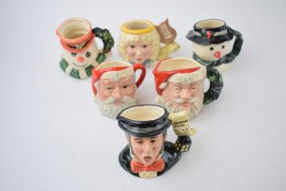 A trio of miniature Royal Doulton character jugs to include The Angel D7051, Santa Claus D6706,