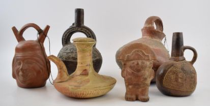 A collection of terracotta oil lamps and similar items in the style of Roman and other ancient