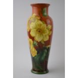 Doulton Lambeth Faience high-shouldered vase decorated with Daffodils on red / deep orange