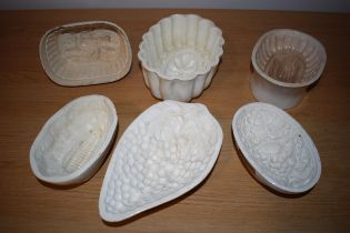 A collection of early to mid 19th century creamware jelly moulds to include makes such as