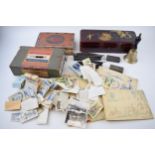 Mixed items to include a small hand bell, 2 cut throat razors, cigarette cards, loose and in