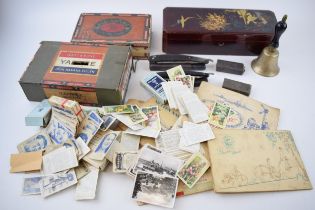 Mixed items to include a small hand bell, 2 cut throat razors, cigarette cards, loose and in