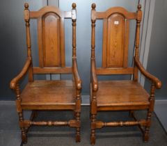 A pair of oak Tudor style carver chairs. Pegged construction. Height 125cm, Width 57cm. In good