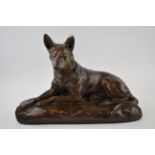 Mid century plaster model of a lying alsatian, with impressed signature / reg number, 40cm long. Ear