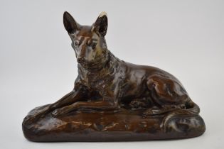 Mid century plaster model of a lying alsatian, with impressed signature / reg number, 40cm long. Ear