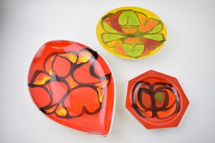 A trio of Poole Pottery dishes of varying and forms and sizes, largest 31cm long (3). In good