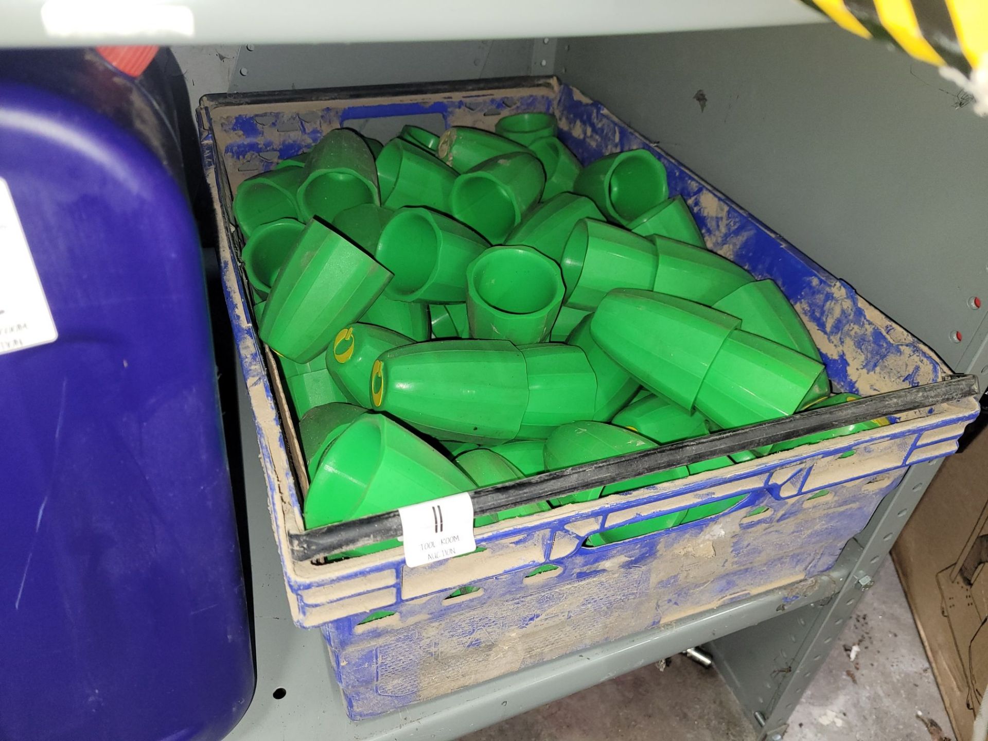 CRATE OF GREEN RUBBER COVERS