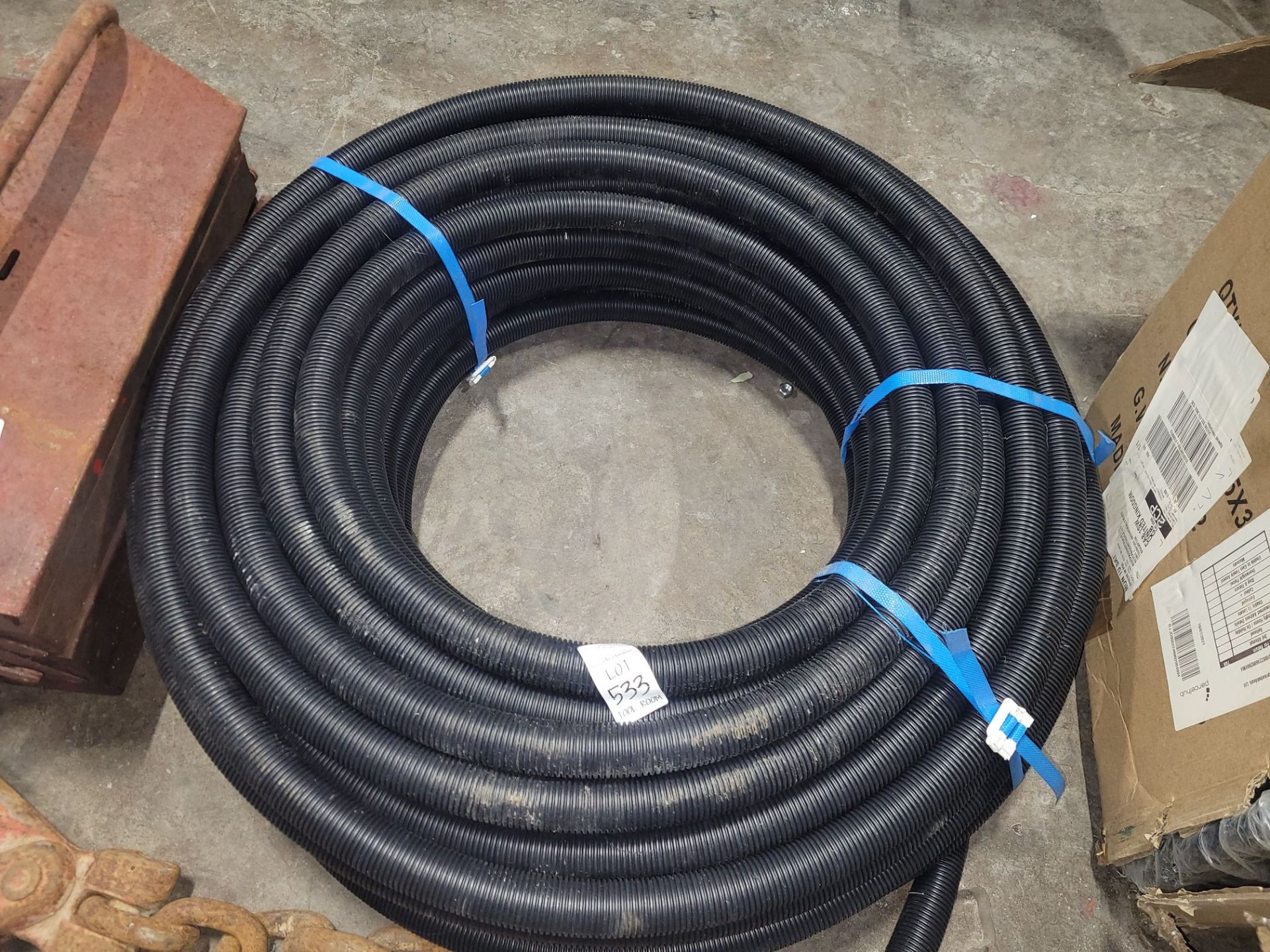ROLL OF BLACK PLASTIC PIPING