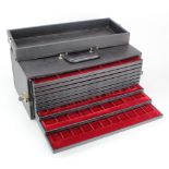 Large carry case of 10 coin trays with varying size spaces.