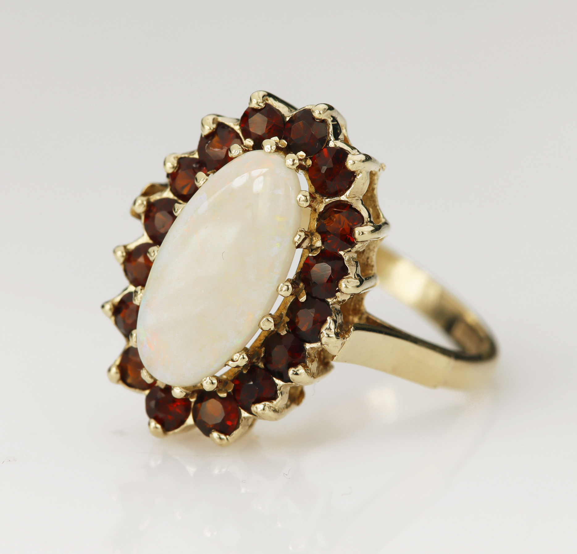 9ct yellow gold opal and garnet cluster dress ring, oval cabochon opal measures 13.8mm x 7mm,