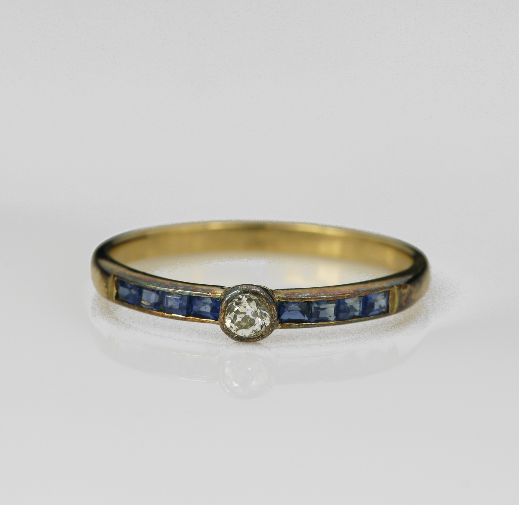 Yellow gold (tests 18ct) Art Deco diamond and sapphire ring, one old cut diamond approx 0.12ct,