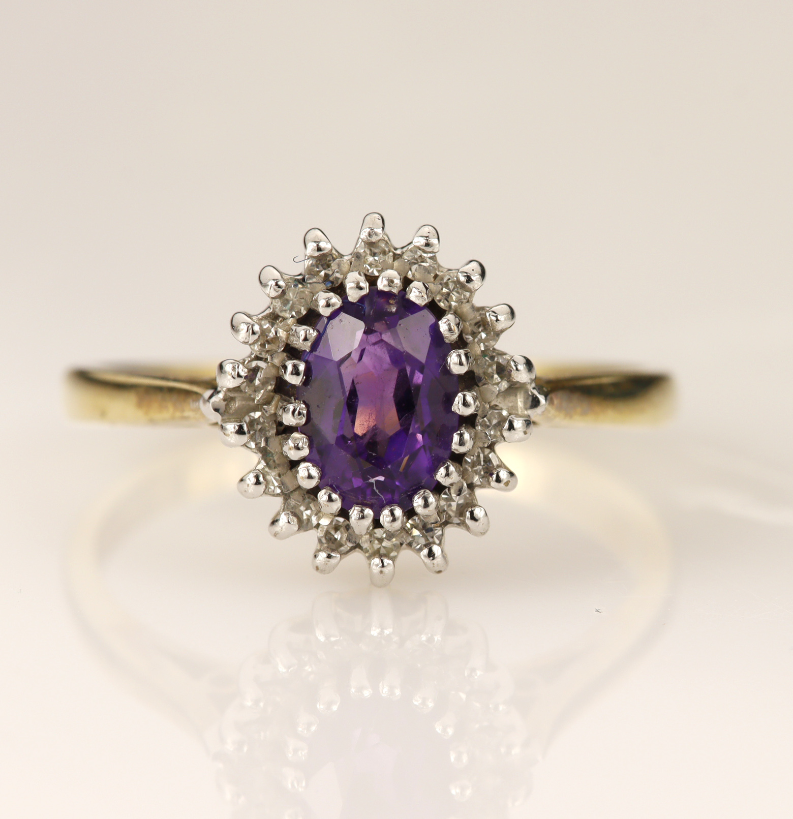 9ct yellow gold diamond and amethyst cluster ring, one oval mixed cut amethyst measures 7mm x 5mm,