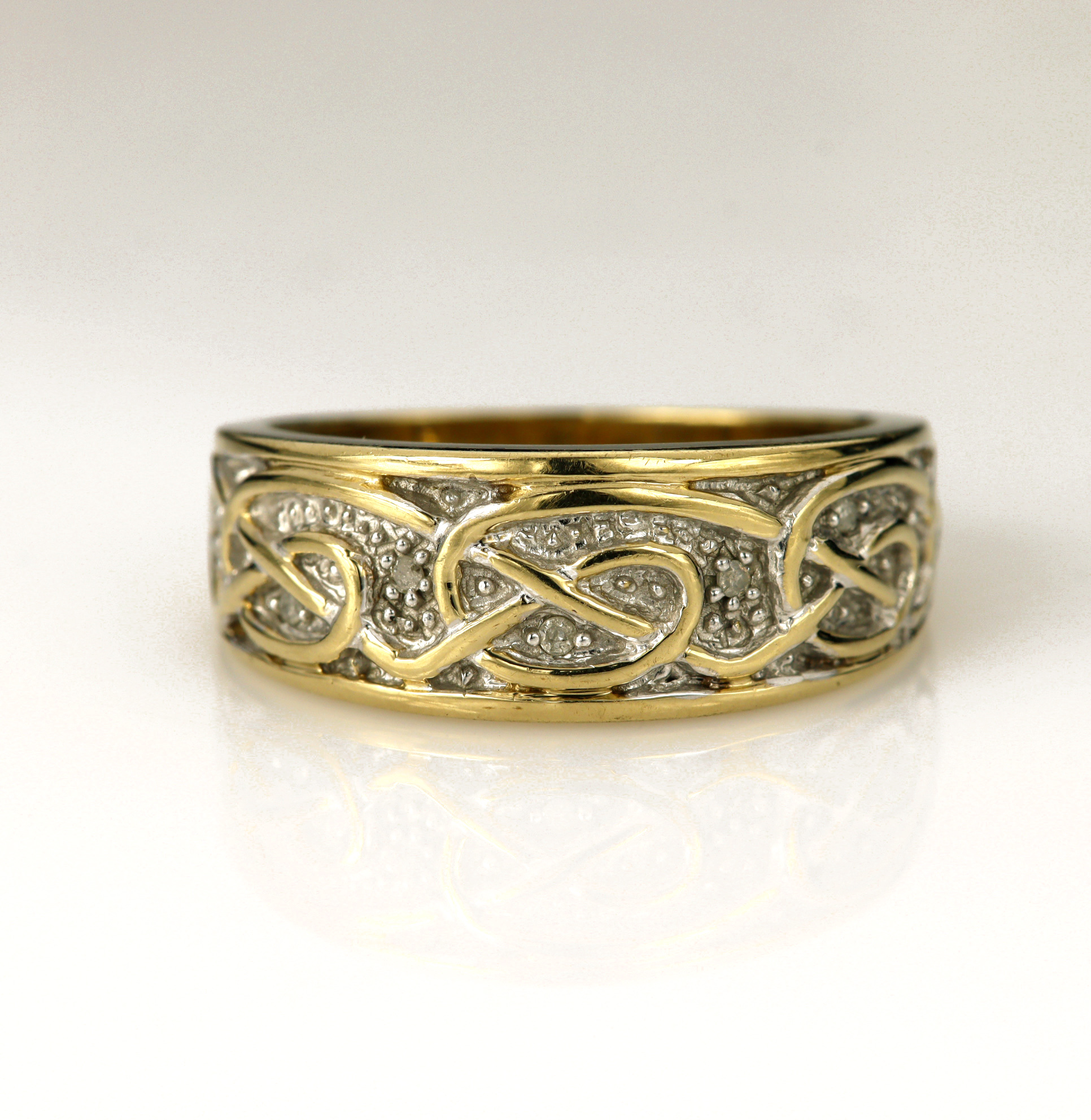 9ct yellow gold Celtic ring, highlighted with white gold and diamonds total weight approx 0.03ct,