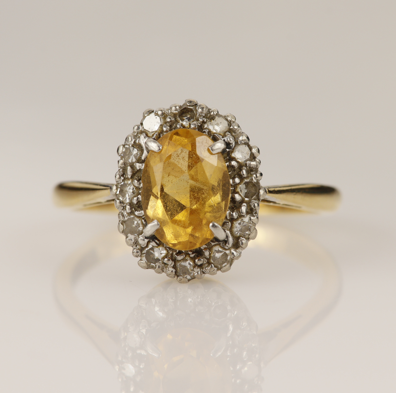 Yellow gold (tests 18ct) diamond and topaz cluster ring, oval mixed cut golden topaz measures 7.