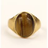 Yellow gold (tests 20ct) tigers eye signet ring, oval cabochon tigers eye measures 14.6mm x 11.