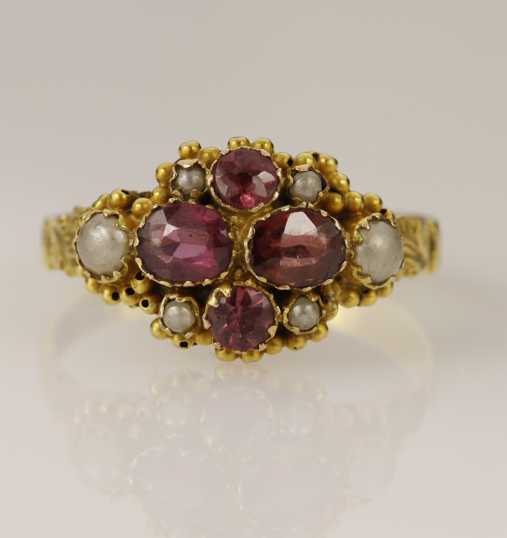 Yellow gold (tests 9ct) pink tourmaline and pearl cluster dress ring, two oval and two round mixed