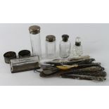 Silver. A collection of various silver and white metal napkin rings, lidded glass jars, button