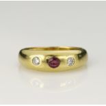 18ct yellow gold diamond and ruby gypsy ring, round mix cut ruby measures 3.3mm, flanked with one