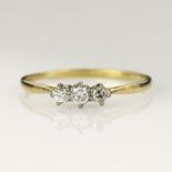 Yellow gold (tests 18ct) trilogy ring, set with three graduating round brilliant cut diamonds,