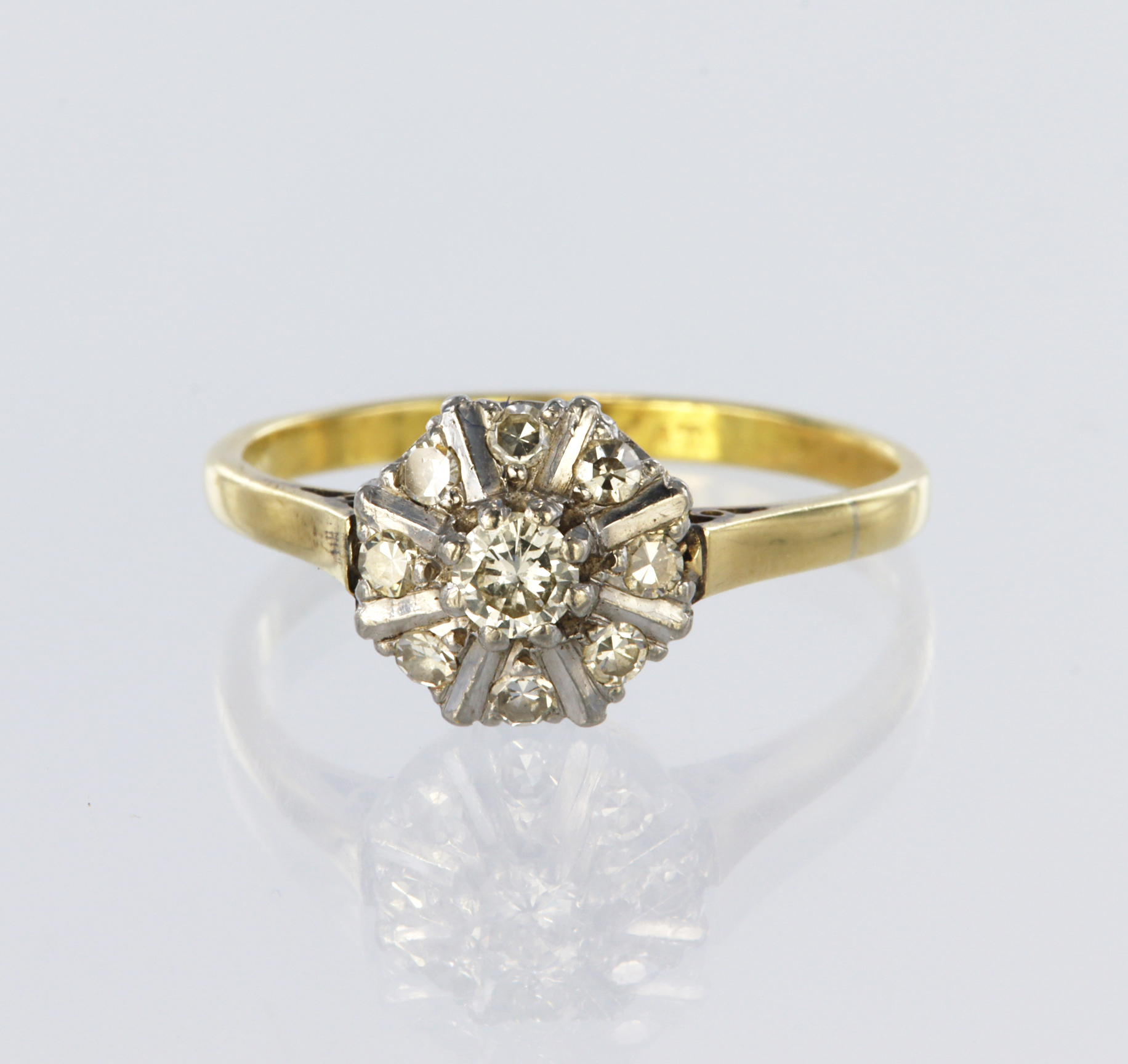 18ct yellow and white gold cluster ring set with a central round brilliant cut diamond weighing