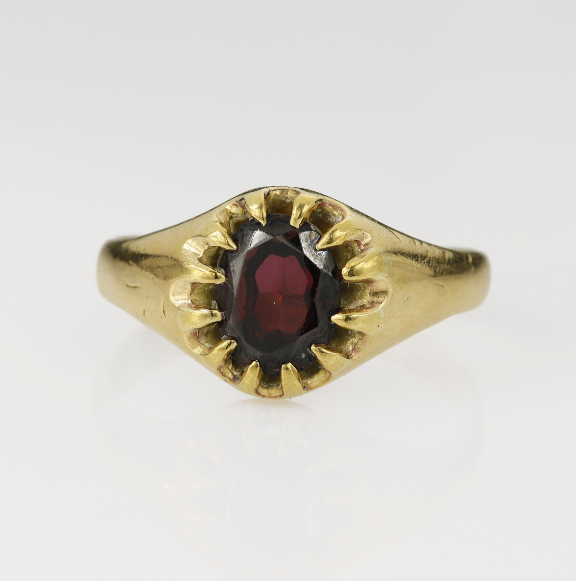 Yellow gold (tests 18ct) garnet soliatire ring, oval cut garnet measures 9.5mm x 7mm, scalloped claw