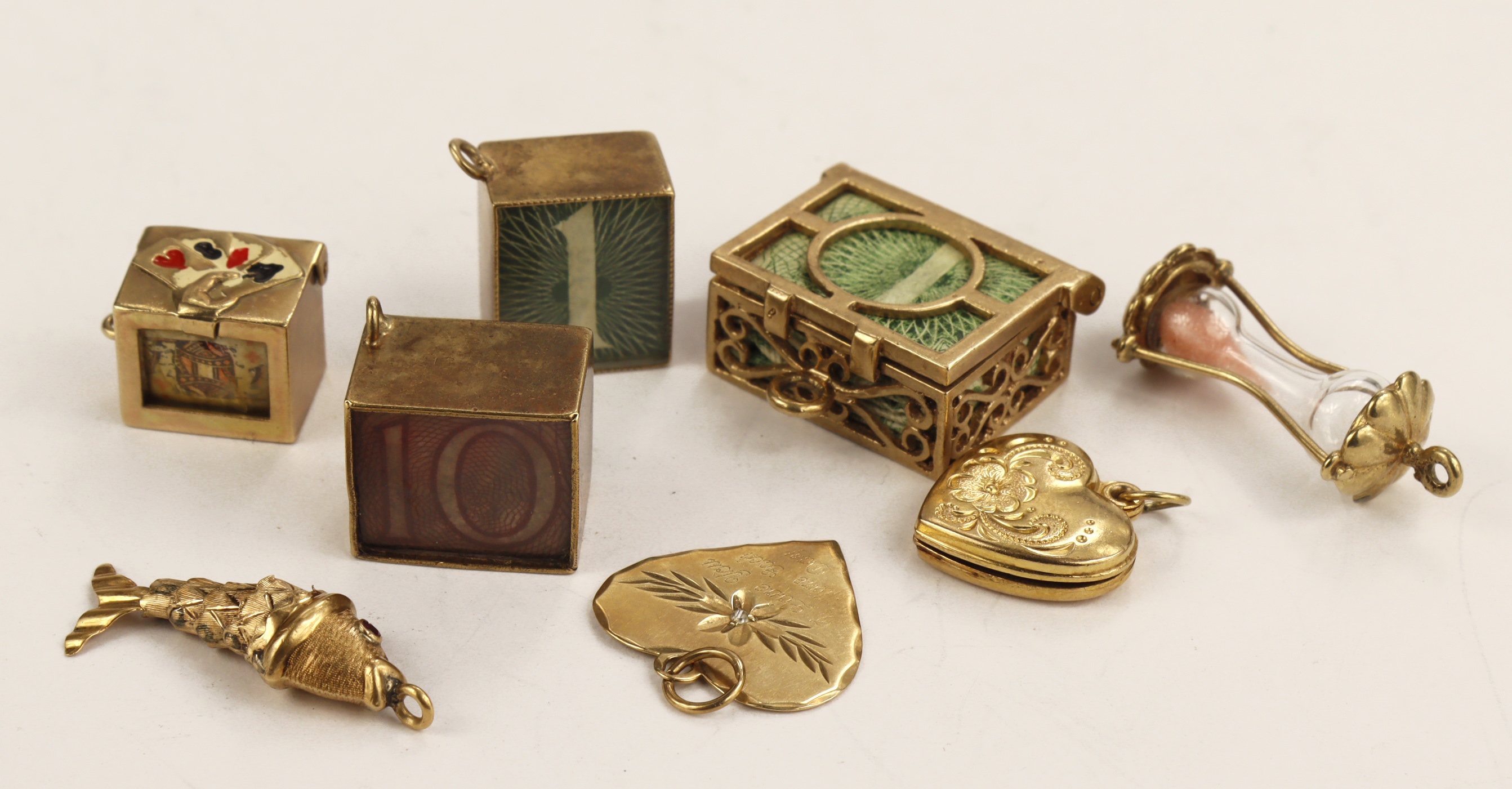 Mixed 9ct / yellow metal charms, includes folded banknote types