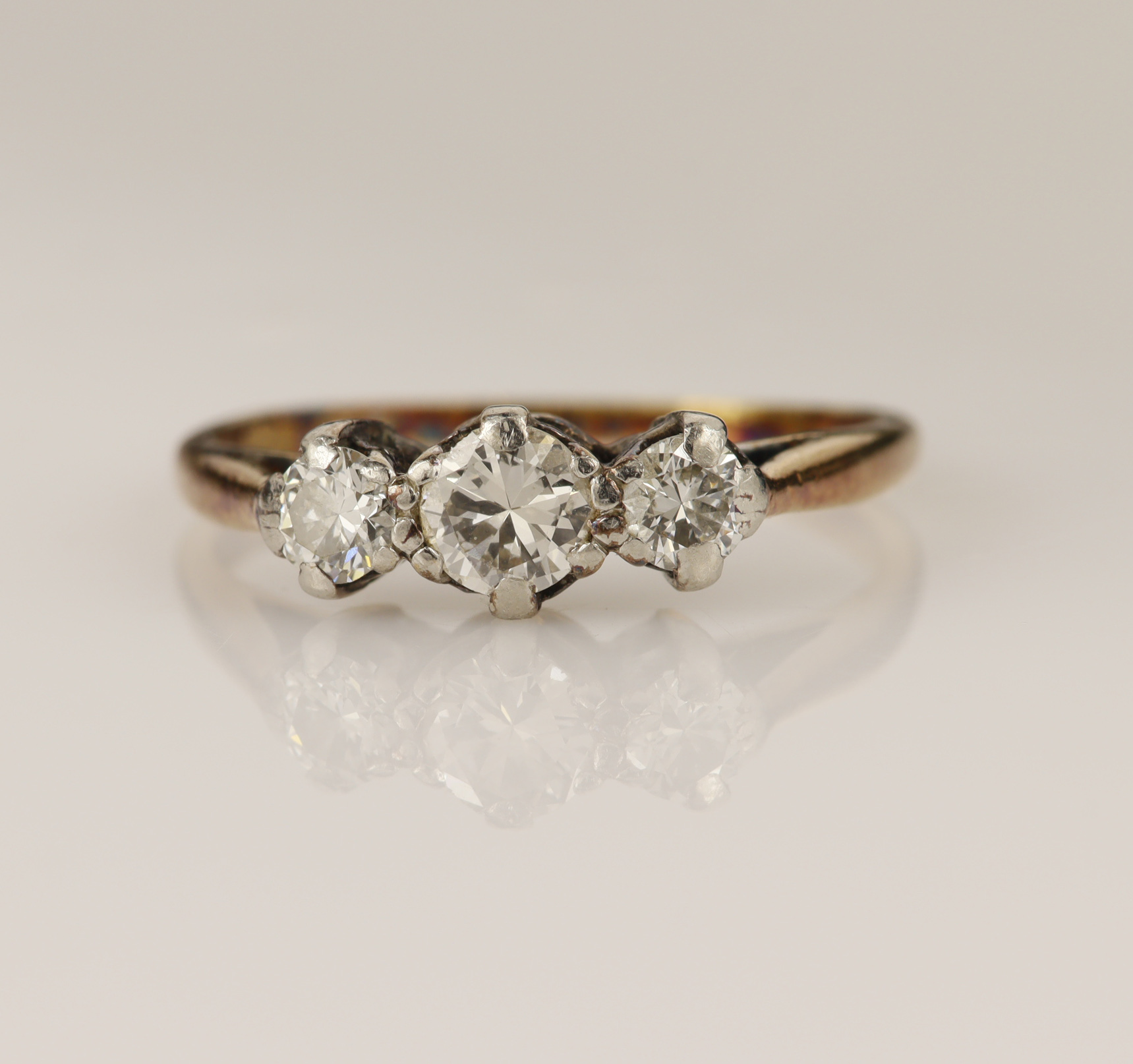 Yellow gold (tests 18ct) diamond set trilogy ring, three graduating round brilliant cuts,