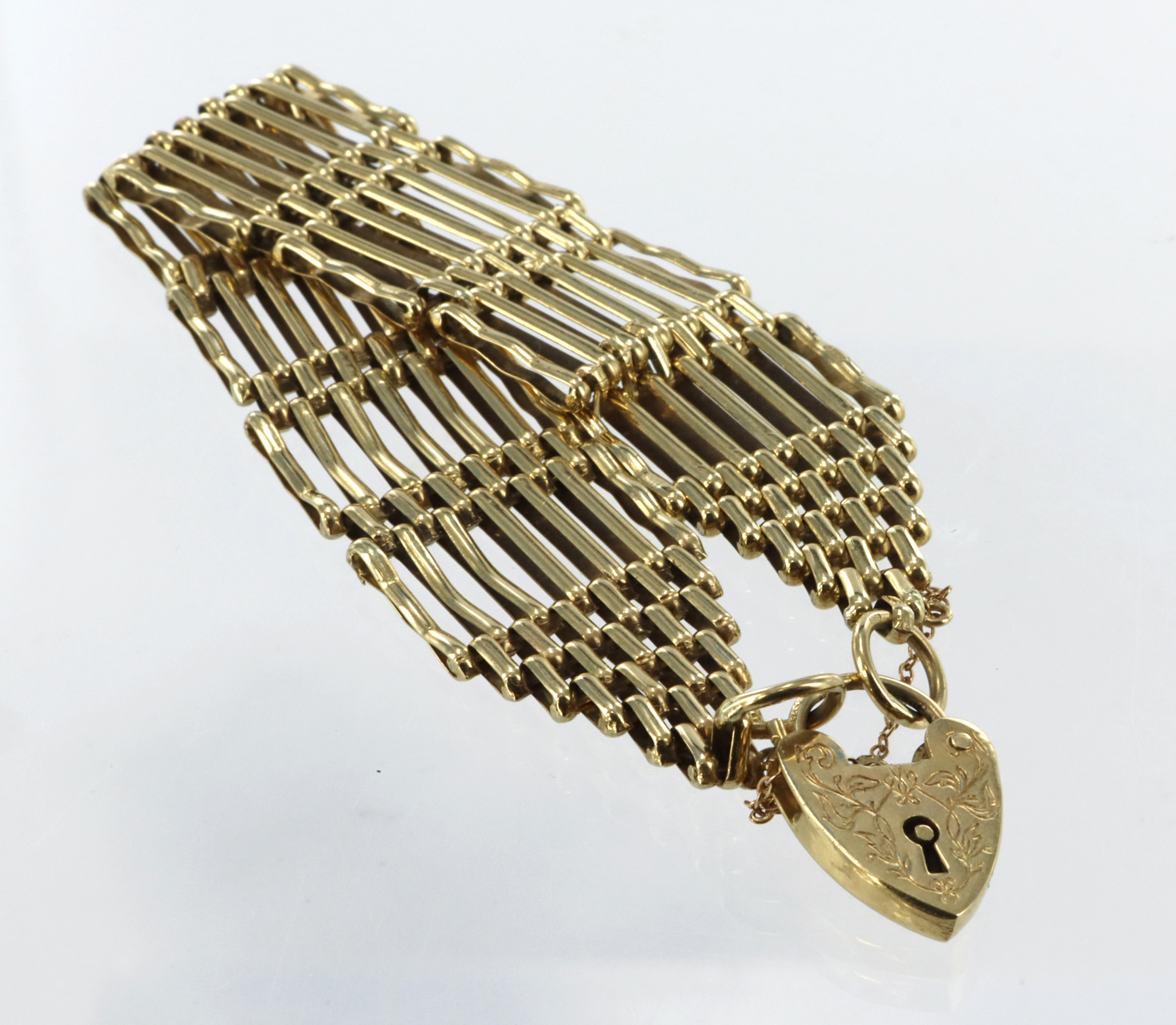 9ct yellow gold seven bar gate bracelet with heart padlock clasp, length 7.5", safety chain