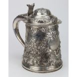 19th century massive Irish silver tankard, profusely embossed with flowers and rococco scrolls