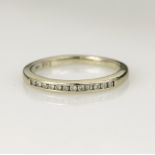 White gold (tests 14ct) diamond half eternity ring, tweleve round brilliant cut diamonds total