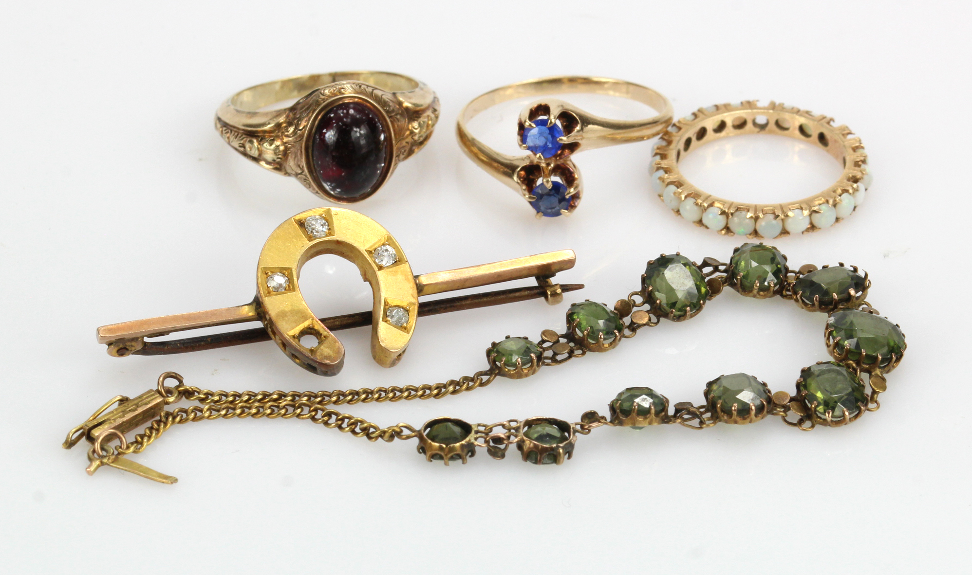 Assortment of yellow gold (tests 9ct) jewellery, to include three rings, one diamond set horse