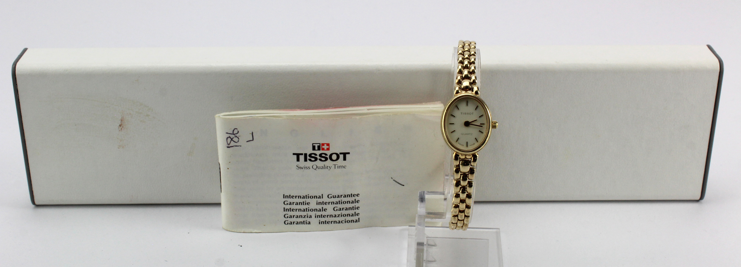 Ladies 9ct cased Tissot quartz wristwatch. On an 9ct bracelet. Total weight 18.1g. Boxed with some