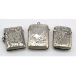 Three engraved vesta cases, two hallmarked for Birm. 1902 and one hallmarked for Birm. 1894. Total