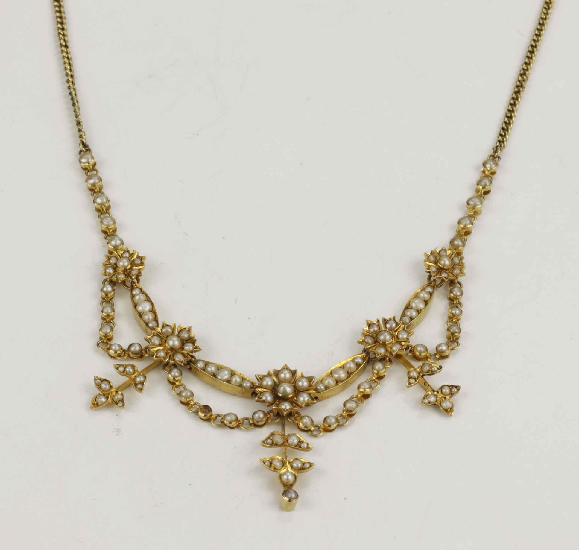 Yellow gold (tests 15ct) Edwardian pearl fringe necklace, set with five graduating half pearl floral