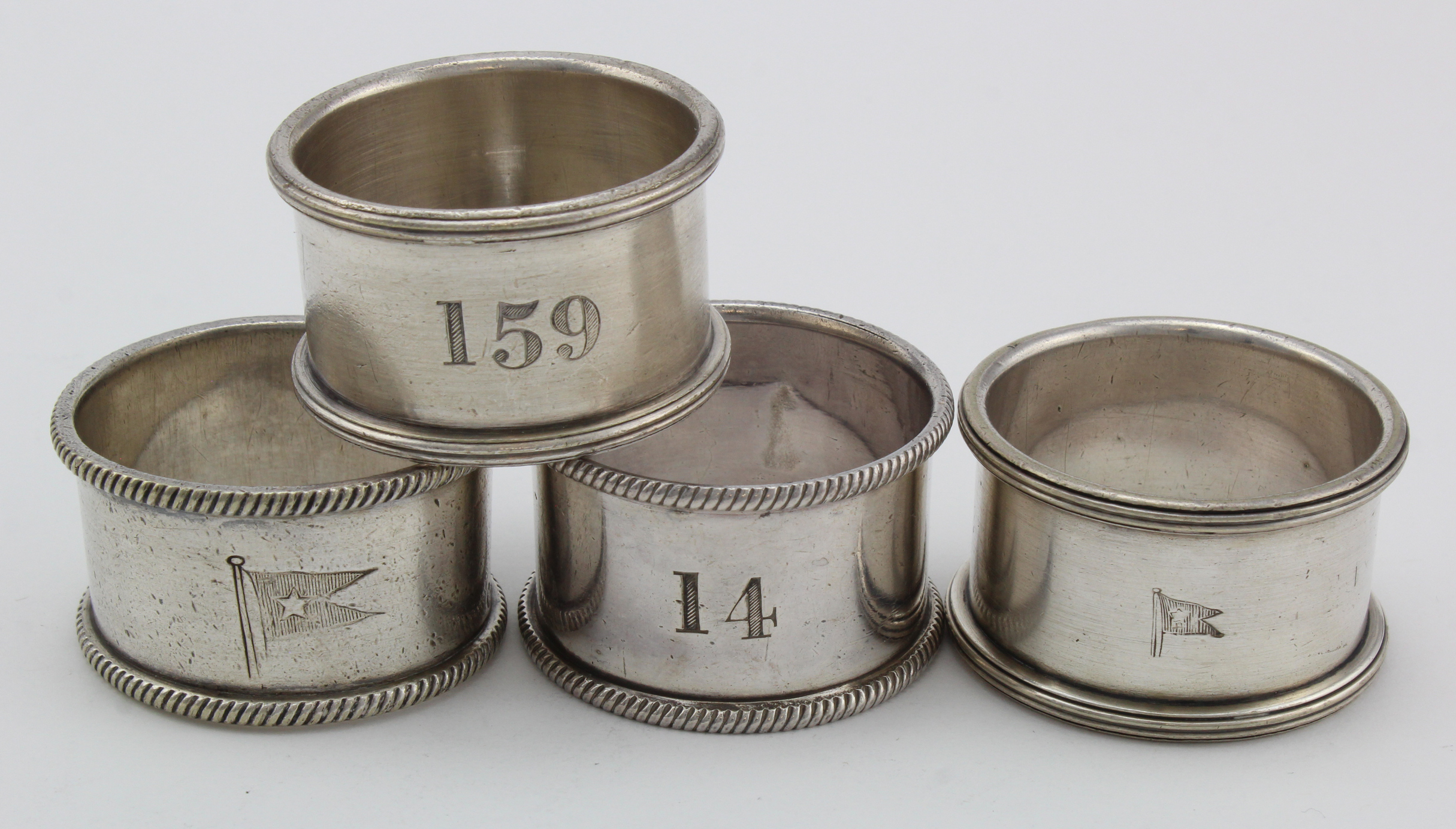 Silver plated White Star Line napkin ring, with engraved flag emblem to side, together with three