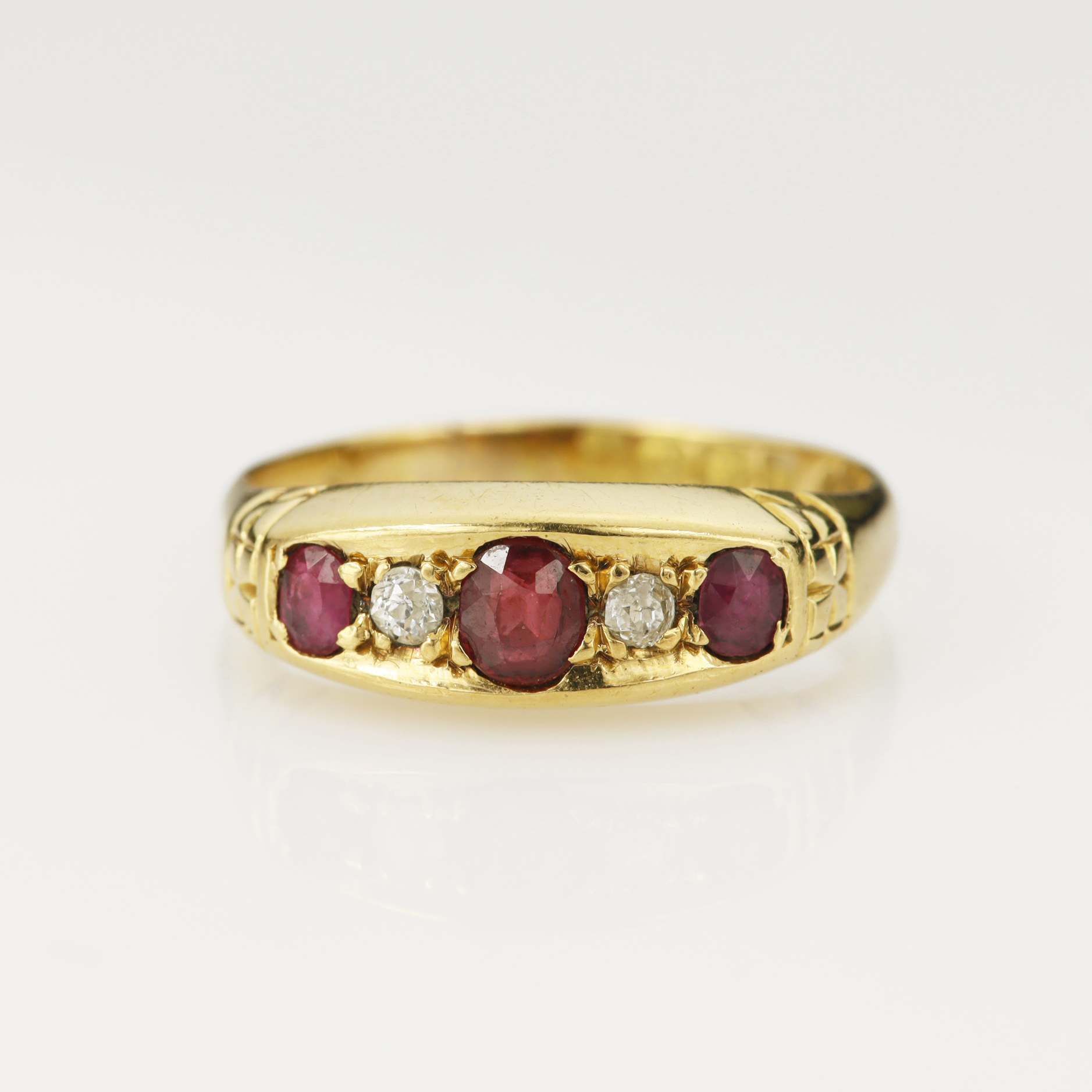 18ct yellow gold Edwardian ruby and diamond ring, set with three graduating oval mix cut rubies