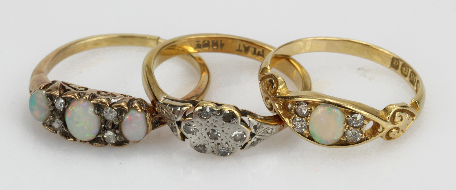 Three 18ct/tests 18ct yellow gold rings, stones include opal and diamonds, all with some damage,