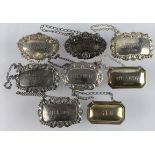 Bottle labels. A collection of eight silver hallmarked bottle labels, including two made for