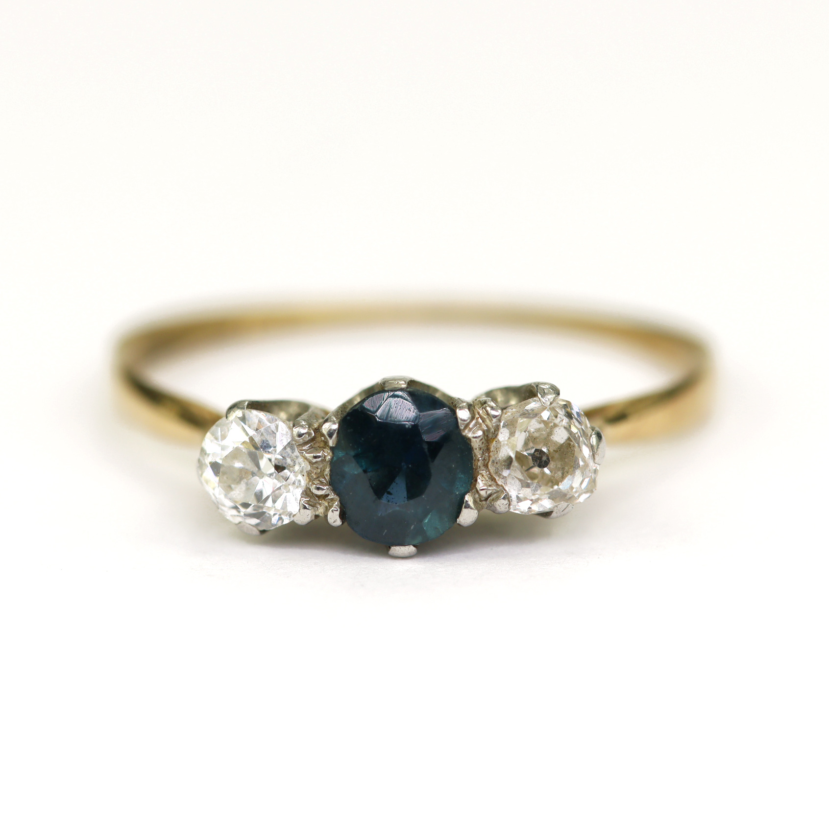 Yellow gold (tests 18ct) diamond and sapphire trilogy ring, round cut teal sapphire measures 4.