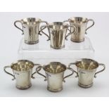 Six silver two handled tot? cups hallmarked JW/FCW (James Wakely & Frank Wheeler) London 1900/